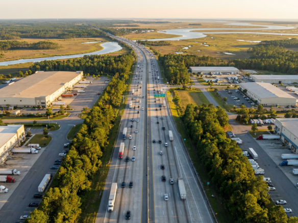 Aerial view of Interstate 95 corridor near Savannah Georgia with industrial warehouses and port infrastructure visible